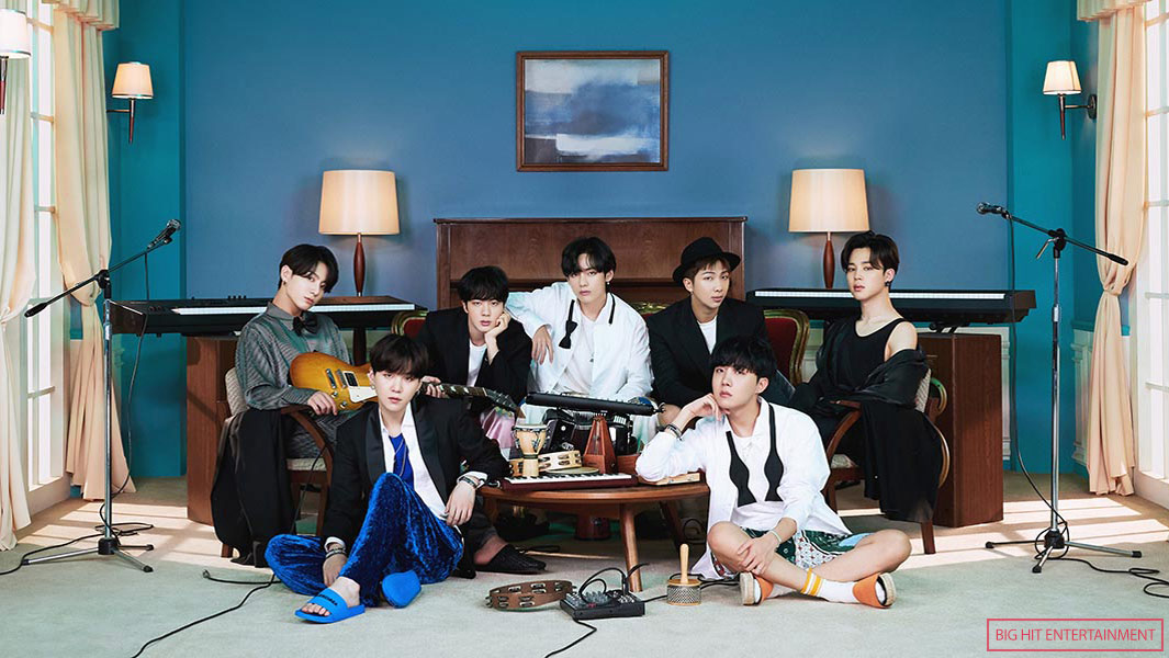 BTS in 2021 sitting around table with instruments with big hit credit