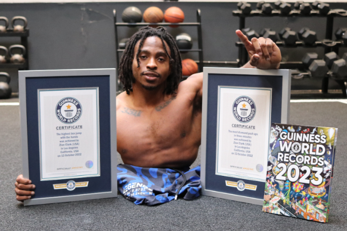 zion-clark-holding-his-gwr-certificates-and-posing-with-gwr-2023-book.jpg