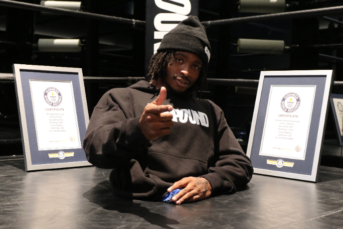 zion-clark-pointing-at-the-camera-and-posing-with-new-gwr-certificates.jpg
